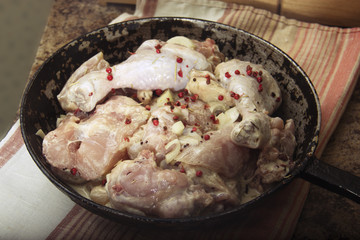 chicken in mustard sauce. raw chicken pieces in the pan. cooking