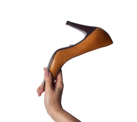 Female hand holding orange shoe