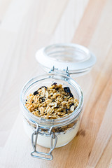 Granola with yogurt in a glass jar