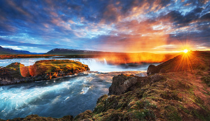 The picturesque sunset over landscapes and waterfalls. Kirkjufel
