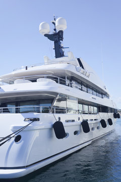 Fototapeta Side of modern private luxury yacht anchored in a small sea port