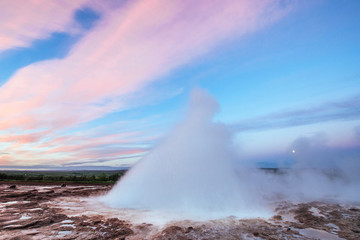 Strokkur geyser eruption in Iceland. Fantastic colors shine thro