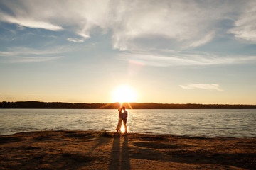 Fototapeta premium Honeymooners on ocean or sea landscape with sun rays. Honeymoon concept