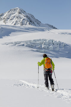Back country skier ploughing through snow, European Alps, Tyrol, Austria