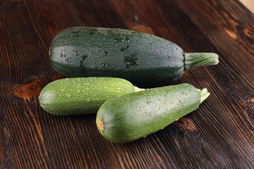 Courgettes on a wooden background.