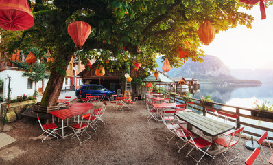 Summer cafe on the beautiful lake between mountains. Alps. Halls