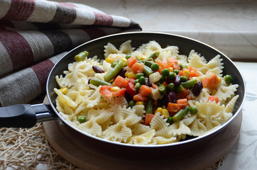 Pasta with vegetables served in a skillet