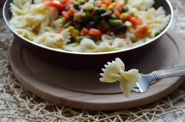 Pasta in the form of a bow on a fork