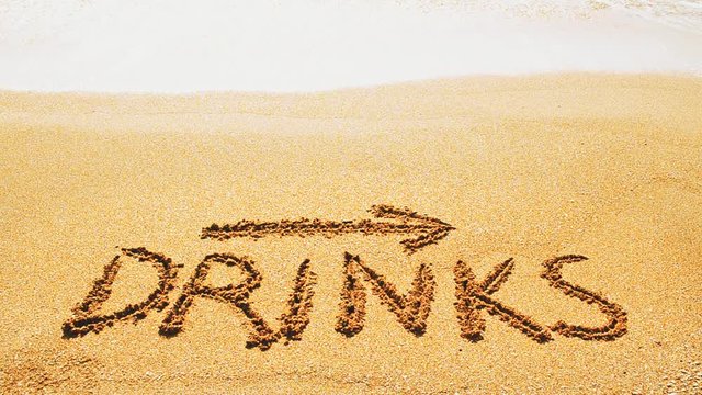 Inscription Drinks and the arrow drawn on the beach sand