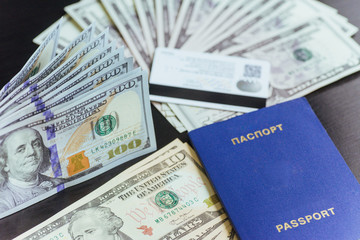 Top view of passport with dollar banknotes on wooden desktop