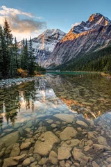 Fototapeten Mount Edith Cavell reflected in the calm river at sunrise in the rocky mountains of Jasper National Park, Alberta, Canada © peteleclerc