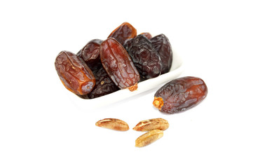 White background in plate with fruit and date fruit seed pictures
