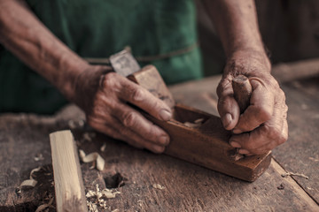 Senior carpenter in his workshop using wood plane, Karanac, Baranja, Croatia