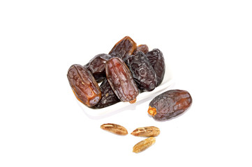 White background in plate with fruit and date fruit seed pictures
