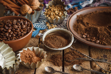 Roasted black and green coffee beans and ground coffee in the plate