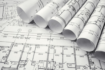 Architect workplace. Architectural project, blueprints, blueprint rolls on wooden desk table....
