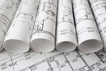 Architect workplace. Architectural project, blueprints, blueprint rolls on wooden desk table. Construction background. Engineering tools. Copy space
