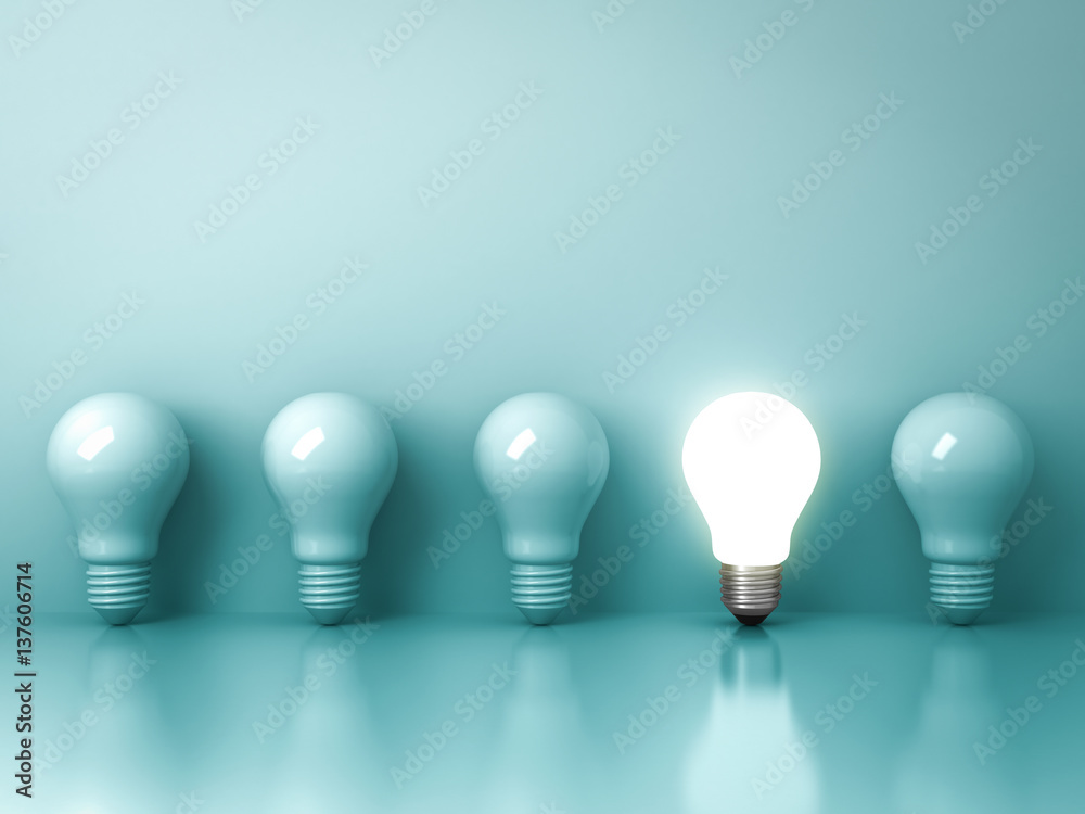Aufkleber one glowing light bulb standing out from the unlit incandescent bulbs on green background with refle