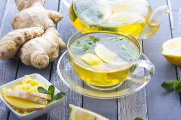 tea ginger lemon mint vintage wood background
