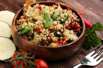 Delicious vegetarian quinoa salad with bell pepper, cucumber and tomatoes