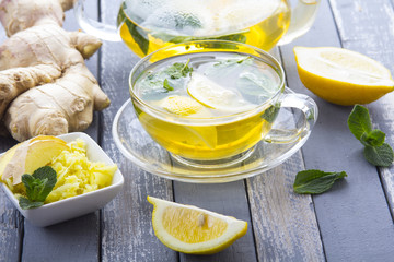 tea ginger lemon mint vintage wood background
