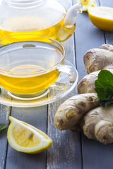 tea ginger lemon mint vintage wood background
