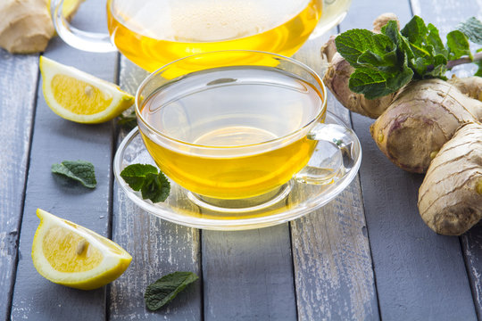 tea ginger lemon mint vintage wood background
