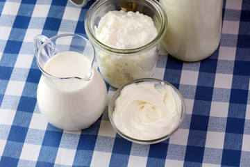 milk products - tasty healthy dairy products on a table on: sour cream in a white bowl, cottage...