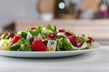 Green salad with blue cheese , raspberry and nuts