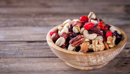 Nuts and dried fruit mix. Concept of Healthy Food. Vintage wooden background. Copy space for Text. selective focus