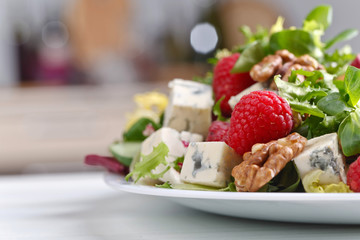 Green salad with blue cheese , raspberry and nuts