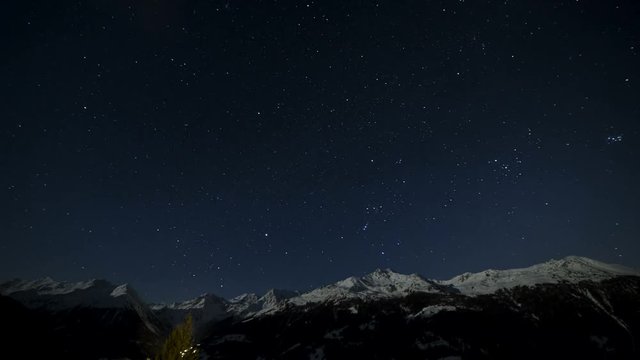Time lapse from sunset till sunrise, with starry night sky and moon over the swiss alps.