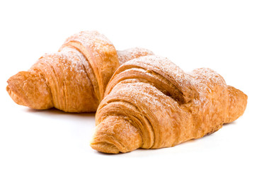 two croissant sprinkled with powdered sugar isolated on a white background closeup