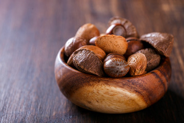 Nuts Mixed on Wooden Background.Assortment, Walnuts,Pecan,Peanuts,Almonds,Hazelnuts,Macadamia,Cashews,Pistachios.Concept of Healthy Eating.Copy space for Text.Vegetarian.selective focus.