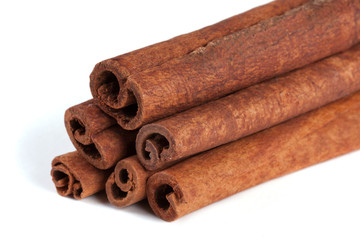 a stack of cinnamon sticks isolated on white background