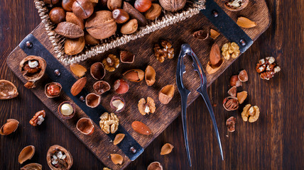 Nuts Mixed on Wooden Background.Assortment, Walnuts,Pecan,Peanuts,Almonds,Hazelnuts,Macadamia,Cashews,Pistachios.Concept of Healthy Eating.Vegetarian.selective focus.