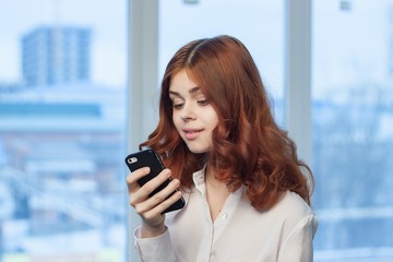 Fototapeta premium surprised woman looks into the phone