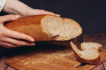 rye bread in hand and a wooden board
