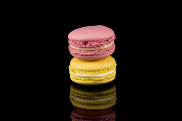 Colorful macaroon over black background