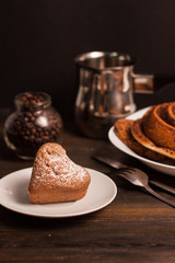 cupcake in a plate, a cup, a roll and coffee beans