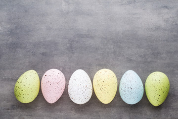 Easter eggs painted in colors on a pattern background.