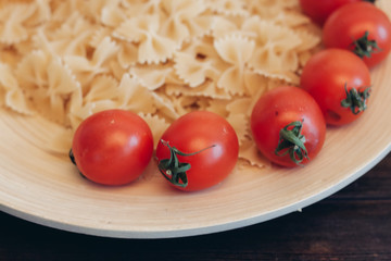 tomatoes and vermicelli on a wooden plate