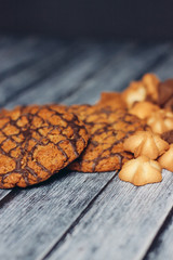 oatmeal cookies decorated with chocolate on a wooden table