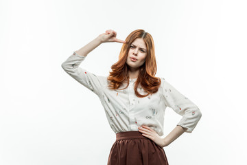beautiful woman on a light background gesticulating with her hands