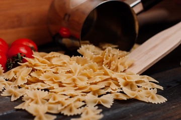 vermicelli and red tomato on the table, wooden kitchen appliance