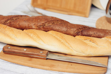 two loaves and a knife on the board