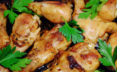 Fried baked chicken drumsticks with herbs. The grilled chicken.