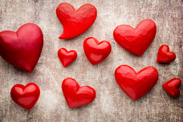 Red hearts on the wooden background.