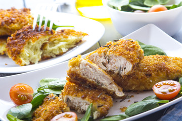 Food fried breading chicken spinach salad tomatoes pancakes from potatoes
