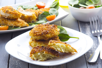 Food fried breading chicken spinach salad tomatoes pancakes from potatoes
